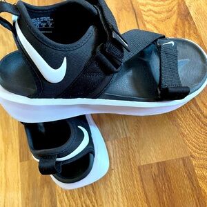 Black Nike sandals with Velcro.
